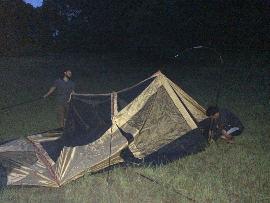 Sean helping Leonel set up his tent for the first time, in the dark