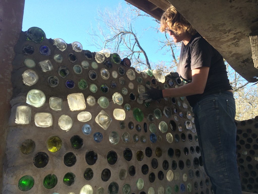 Ali mortaring bottles into the wall