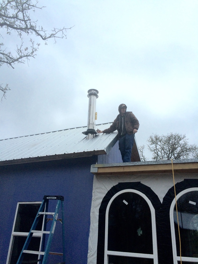 Shane putting the finishing touches on the new woodstove chimney (oops this pic is actually from the last days of December)