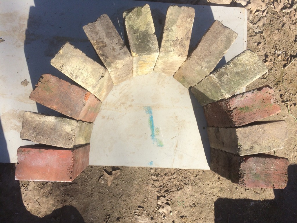 laying out the arch, using scavenged homestead bricks. Old bricks are actually better than most modern bricks for durability under heat stress.