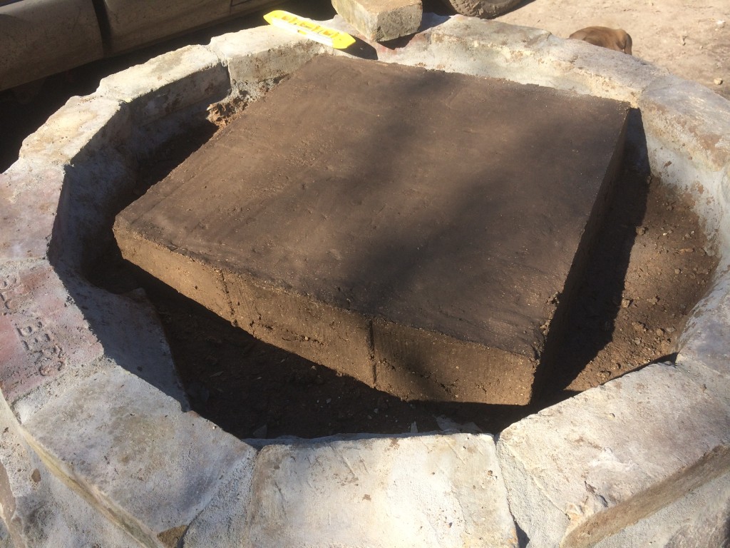 We created a wood frame and packed it with the oven mud to make a subfloor heat pad