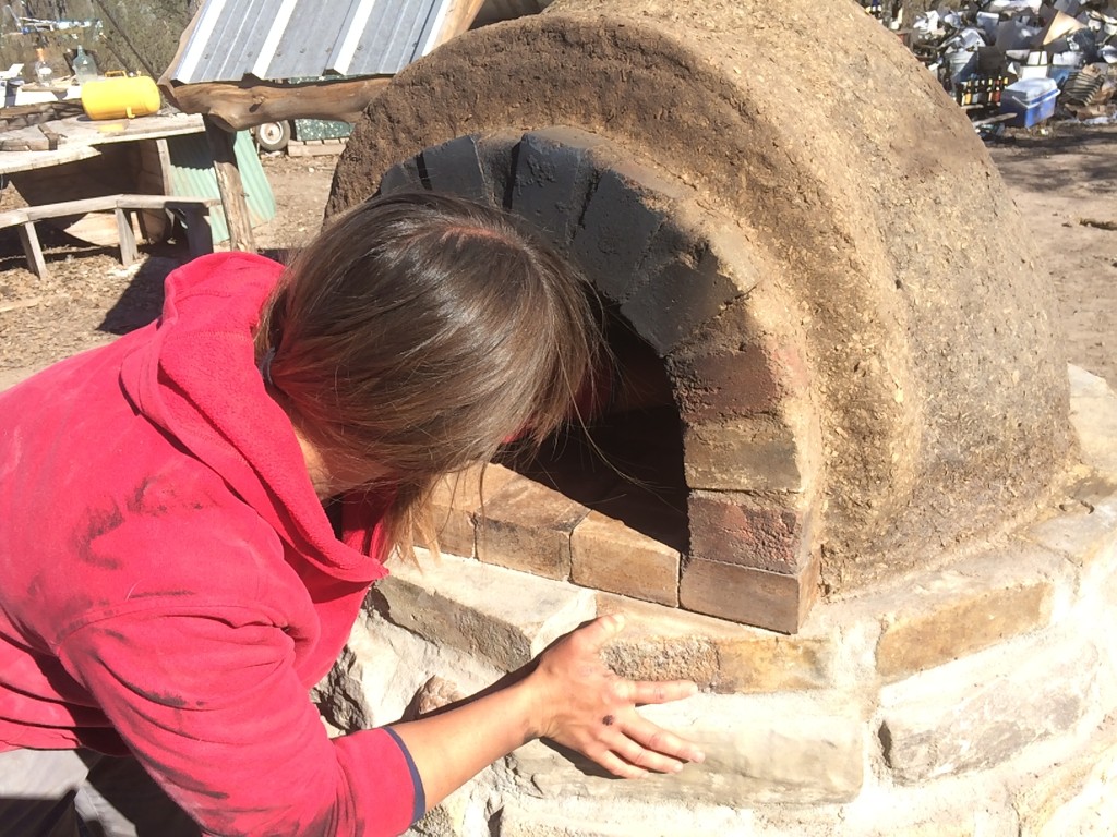 cleaning out the last of the sand. the insulation layer has baked almost dry, so we let the long drying fire go out, in preparation for the final exterior clay