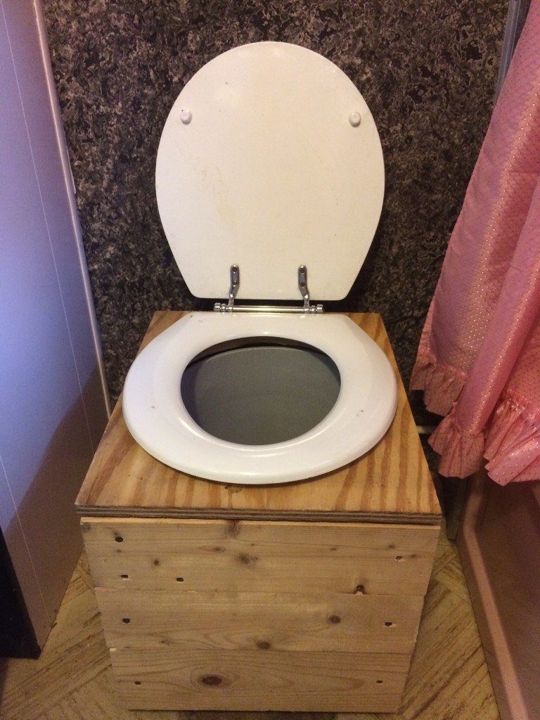 added a sawdust bucket composting toilet to the guest trailer