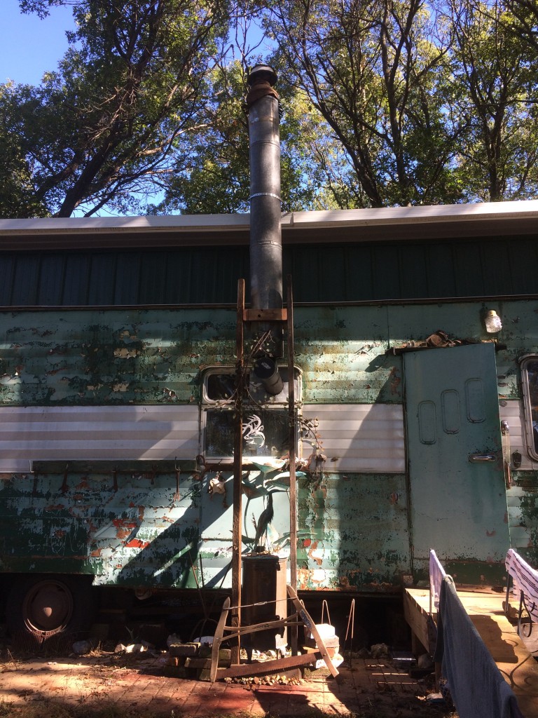 all done - topped off with the amazing milk can chimney cap from the ruins of Old Henry's place (where we got the car panel siding to build the Rust Shack) 