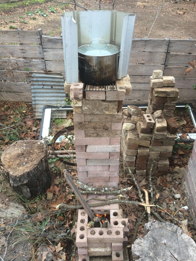 the simple rocket stove we built last year, keeping water boiling for feather plucking