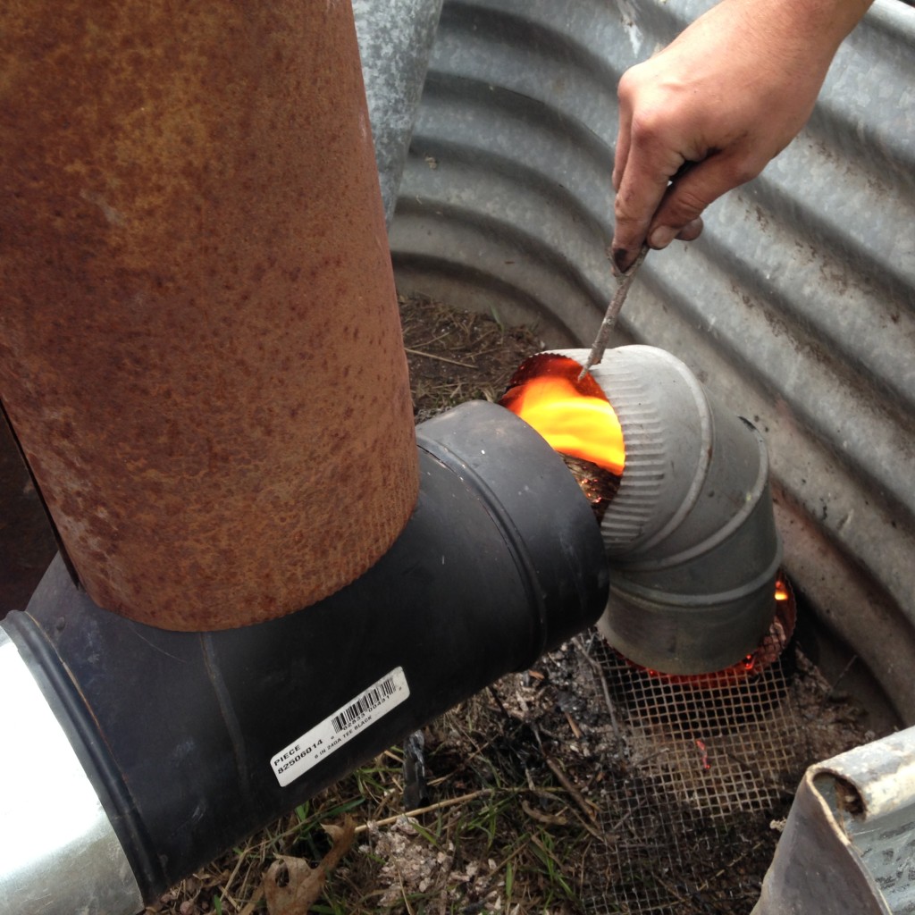 Booster fire! This proved crucial during the bench-drying phase for a fast drafting system with hot, oxygen rich flame - the little fire would be pulled up the chimnet, creating suction on the rest of the system, pulling air through the fire in the combustion chamber. (Now that it is dried out, we only use this to start the system up, to avoid cold air plugging up the system)