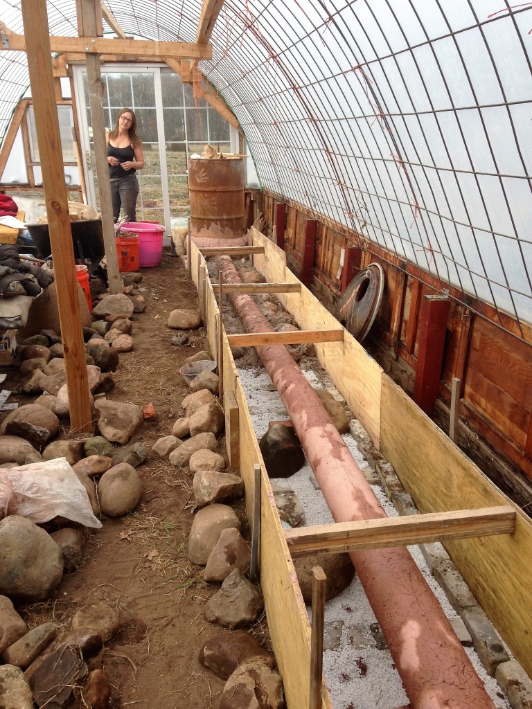 slowly filling the forms with clay/sand mix and rocks. Kristin down at her mixing station.