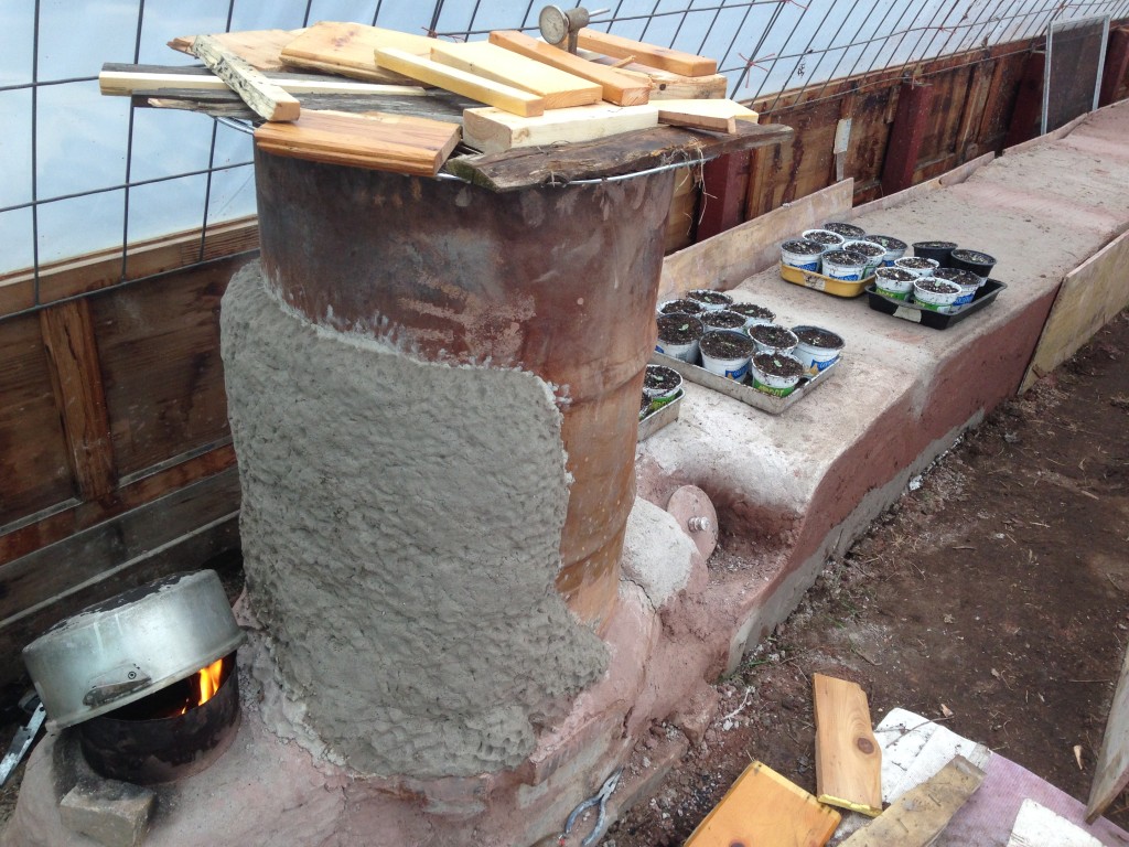 added some thermal mass to the barrel to limit amount of heat lost to radiation off the metal. Using the heat at the top for a wood drying rack. Artichokes enjoying the radiant heat.