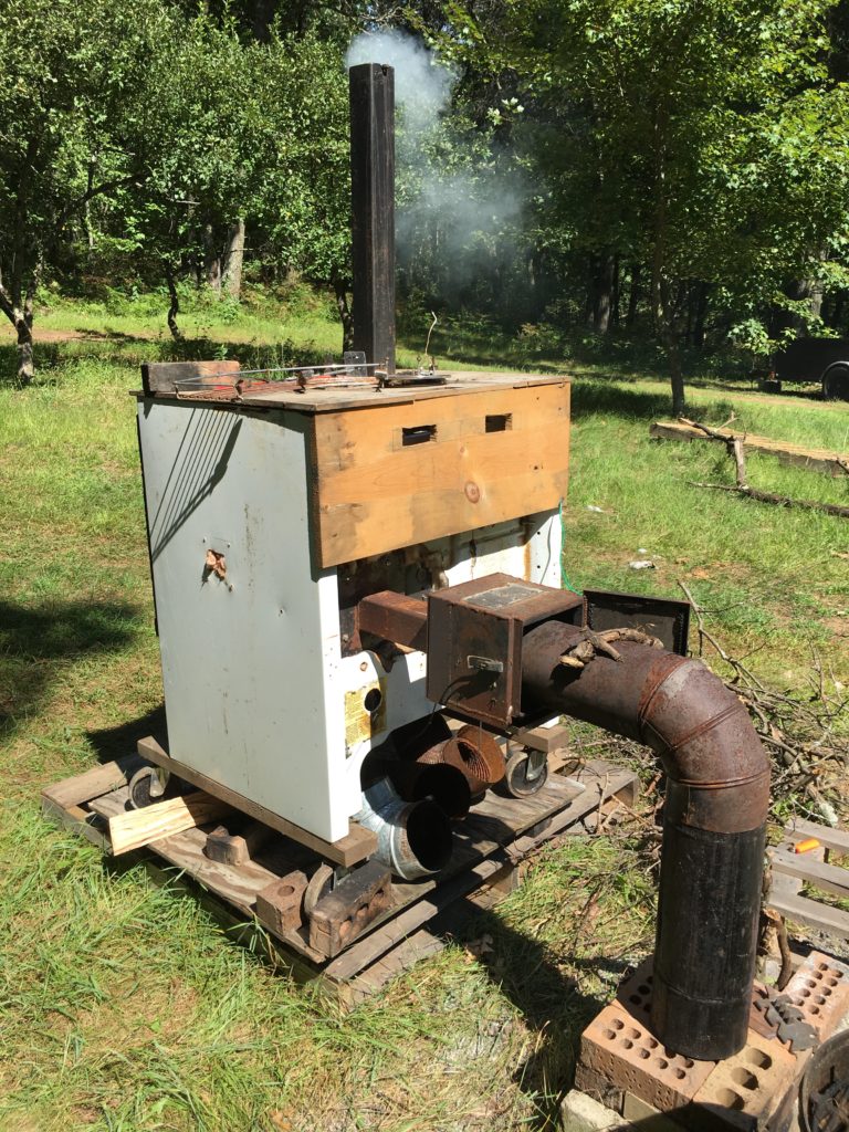 Free Craigslist oven turned electric smoker converted to run from a rocket stove instead - our smoker