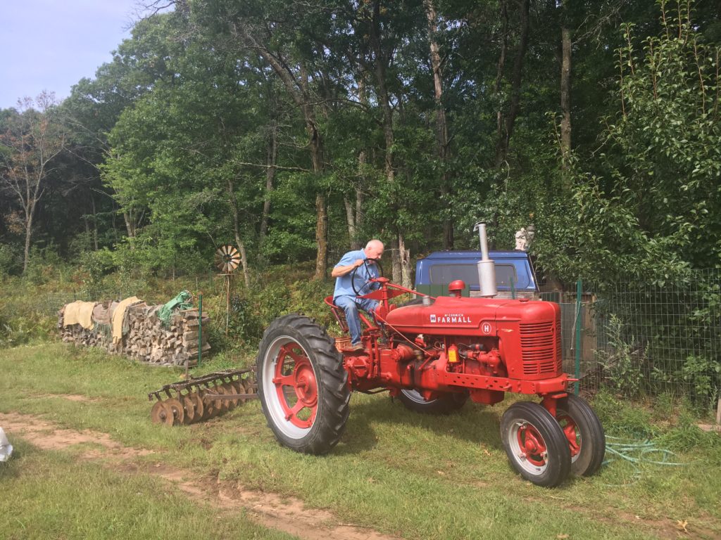 Grandpa Jim moves some of the old implements out of the pear tree patch